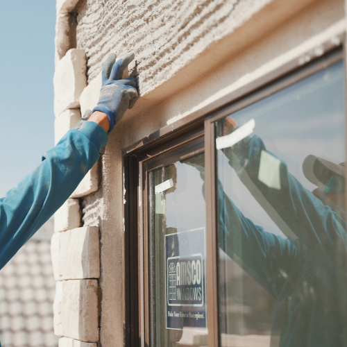 Mason installing stone veneer on a home exterior in Southern Utah